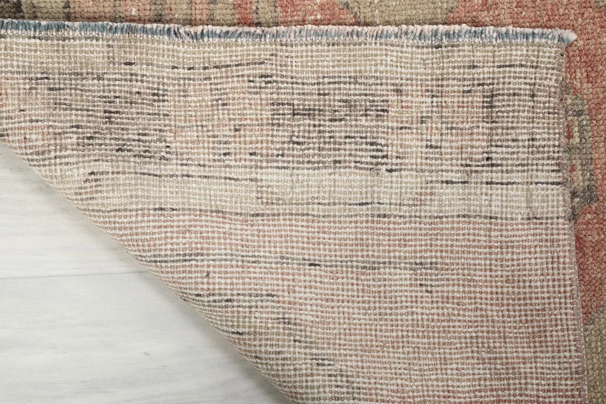 Underside of the hand-knotted rug, revealing the cotton foundation and knotting structure.