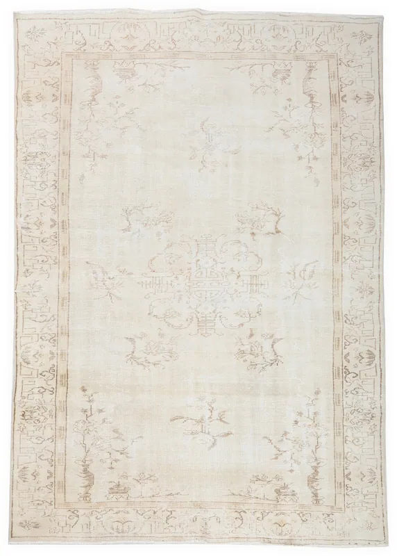 Full top view of a hand-knotted vintage Anatolian rug with cream field and subtle beige patterns