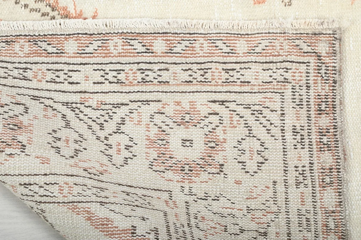 View of the back of the hand-knotted rug, revealing the cotton foundation and knotting