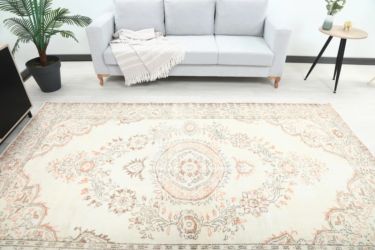 Overhead view of the ivory and rust vintage rug highlighting its full design in a room