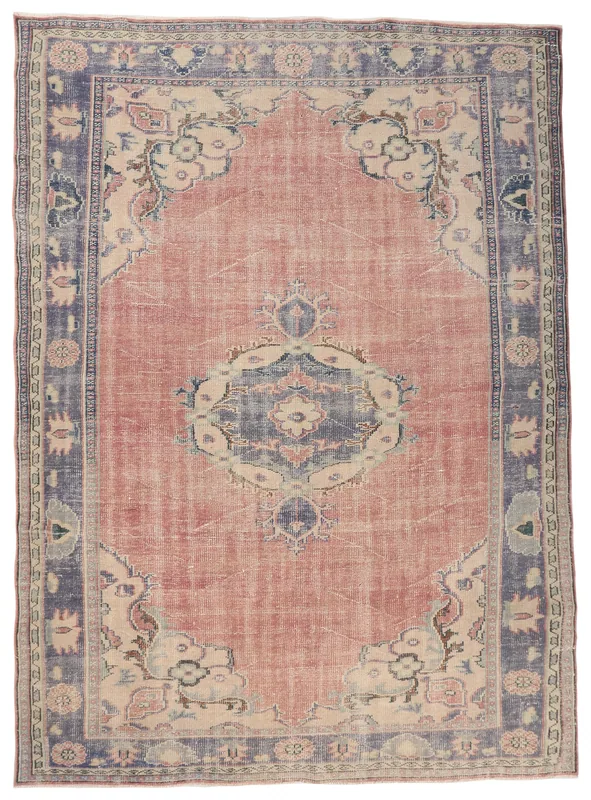 Full overhead view of the vintage rose and navy medallion rug on a white background
