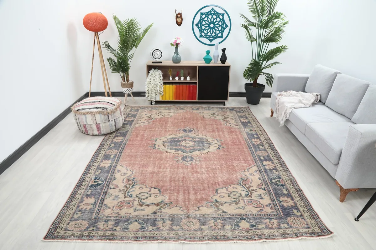 Full view of the hand-knotted rose and navy rug in a modern living space