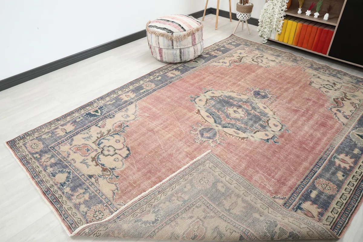 Angled view of the rug with a corner folded back, revealing the reverse side and fringes