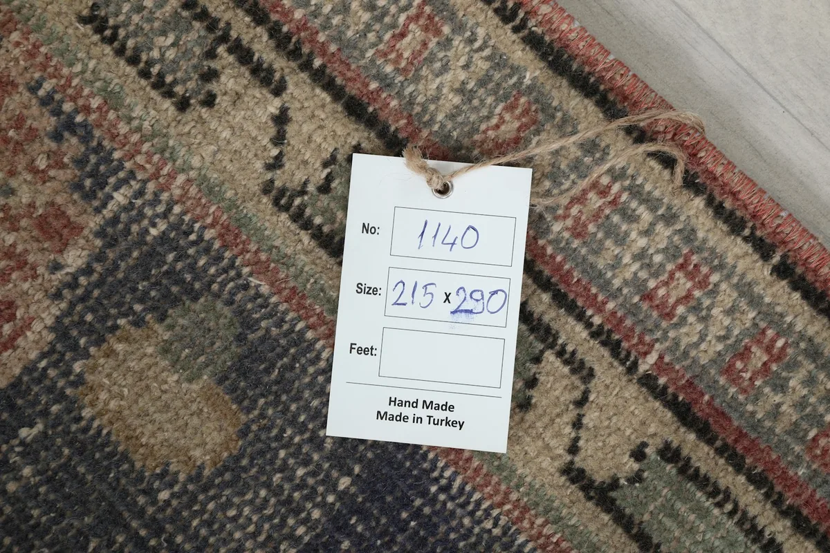 Tag on the rug showing the item number and size in centimeters, confirming hand-made in Turkey