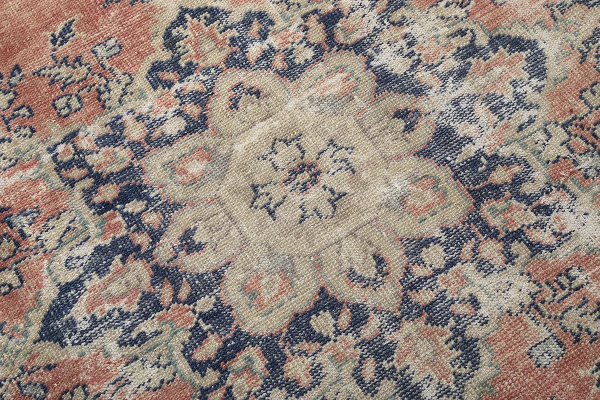 Close-up detail of the central navy and beige medallion motif