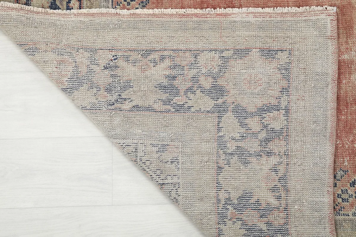 Close-up of the hand-knotted cotton foundation visible from the back of the rug