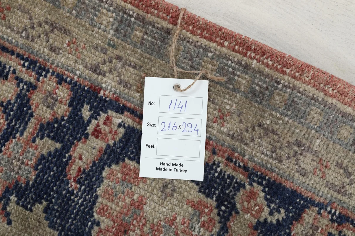 Tag showing the rug's dimensions in centimeters and 'Hand Made in Turkey'