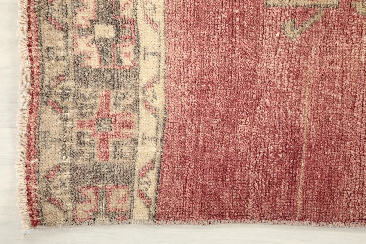 Close-up of the rug's end border, showcasing the transition from the main field to the fringe.