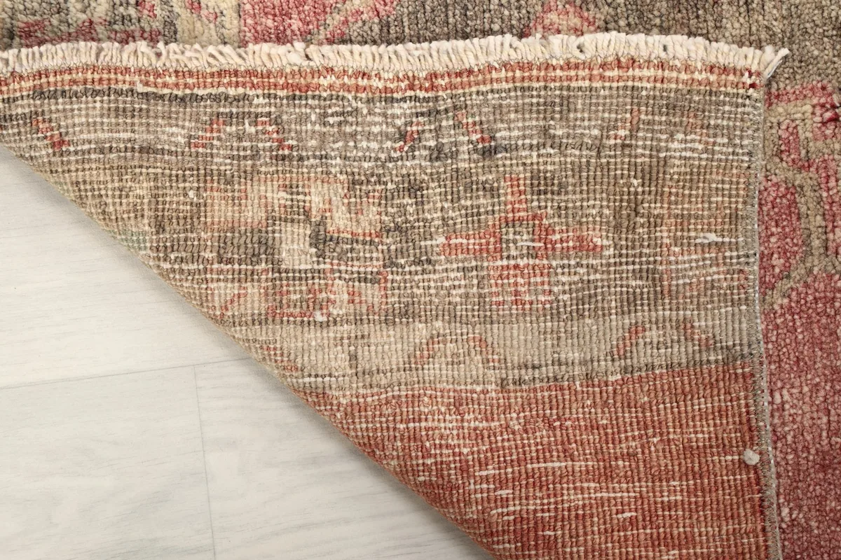 View of the back of the hand-knotted rug, showing the cotton foundation and knotting detail.