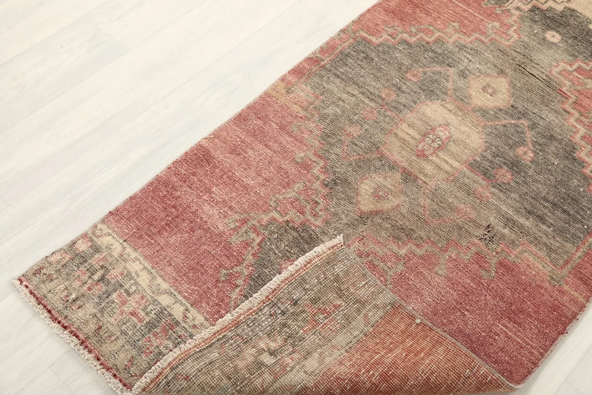 Rug corner folded to reveal the thickness of the wool pile and the texture of the weave.