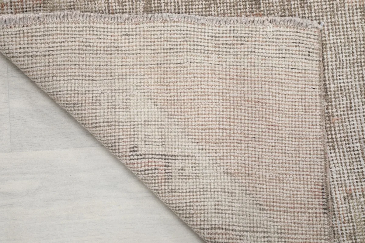 View of the back of the hand-knotted runner rug, showcasing the cotton foundation