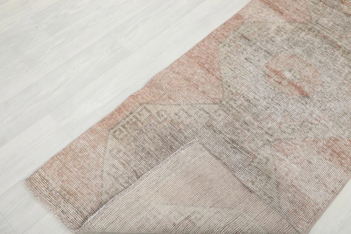 Folded section of the runner rug, showing the wool pile and cotton foundation texture