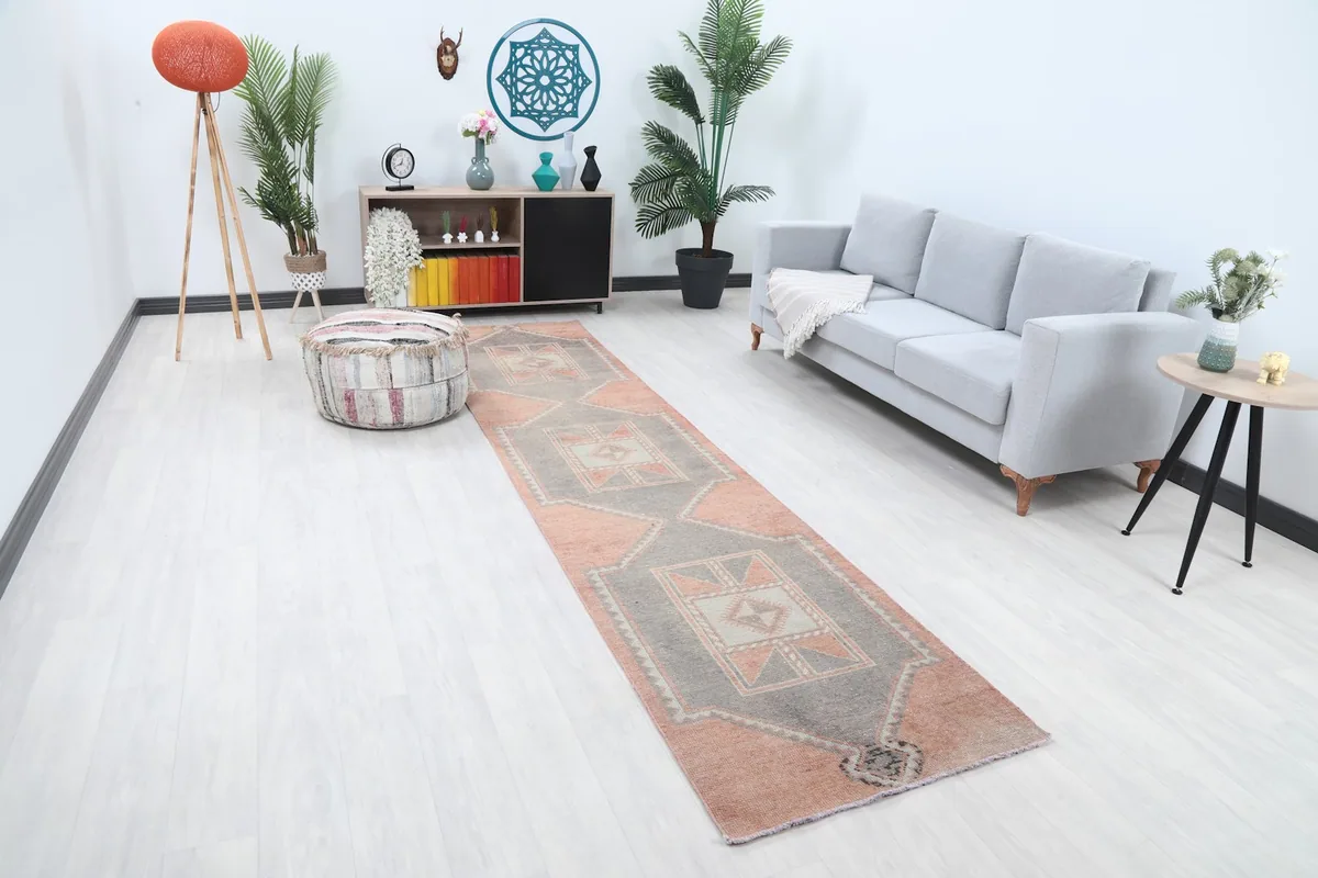 Runner rug in a hallway, showing its length and colors with surrounding decor