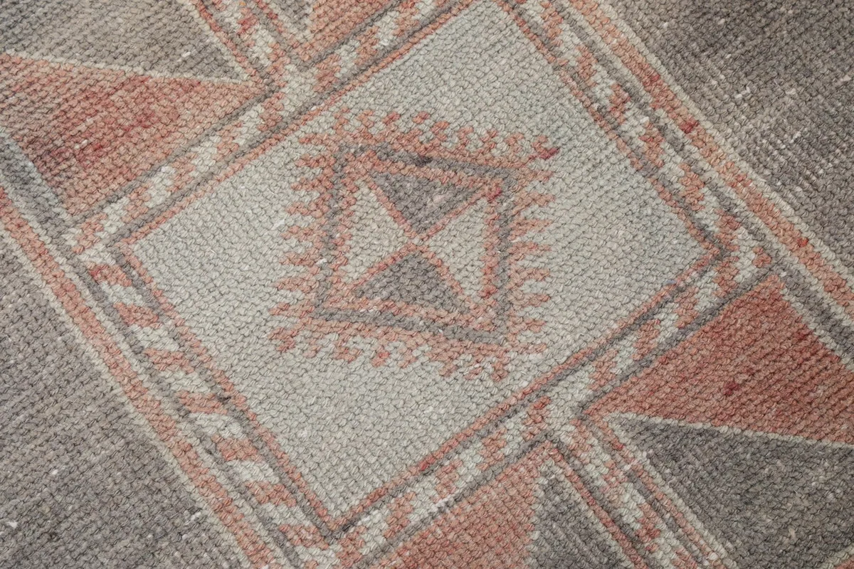 Close-up of the hand-knotted wool pile and intricate tribal patterns