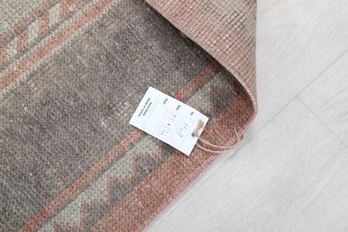 Close-up of the rug's tag, displaying item information and details