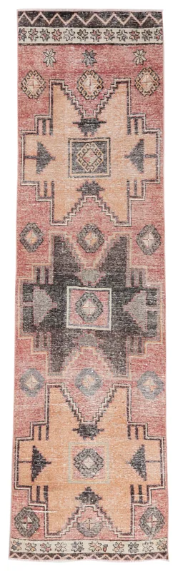Full overhead view of a vintage Anatolian runner rug with rust, black, and beige geometric patterns