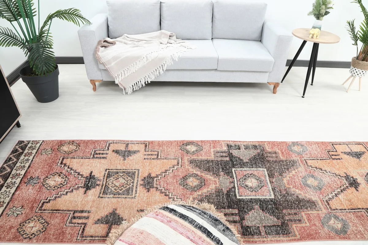Overhead view of the rug in a room, showing its placement in front of a sofa