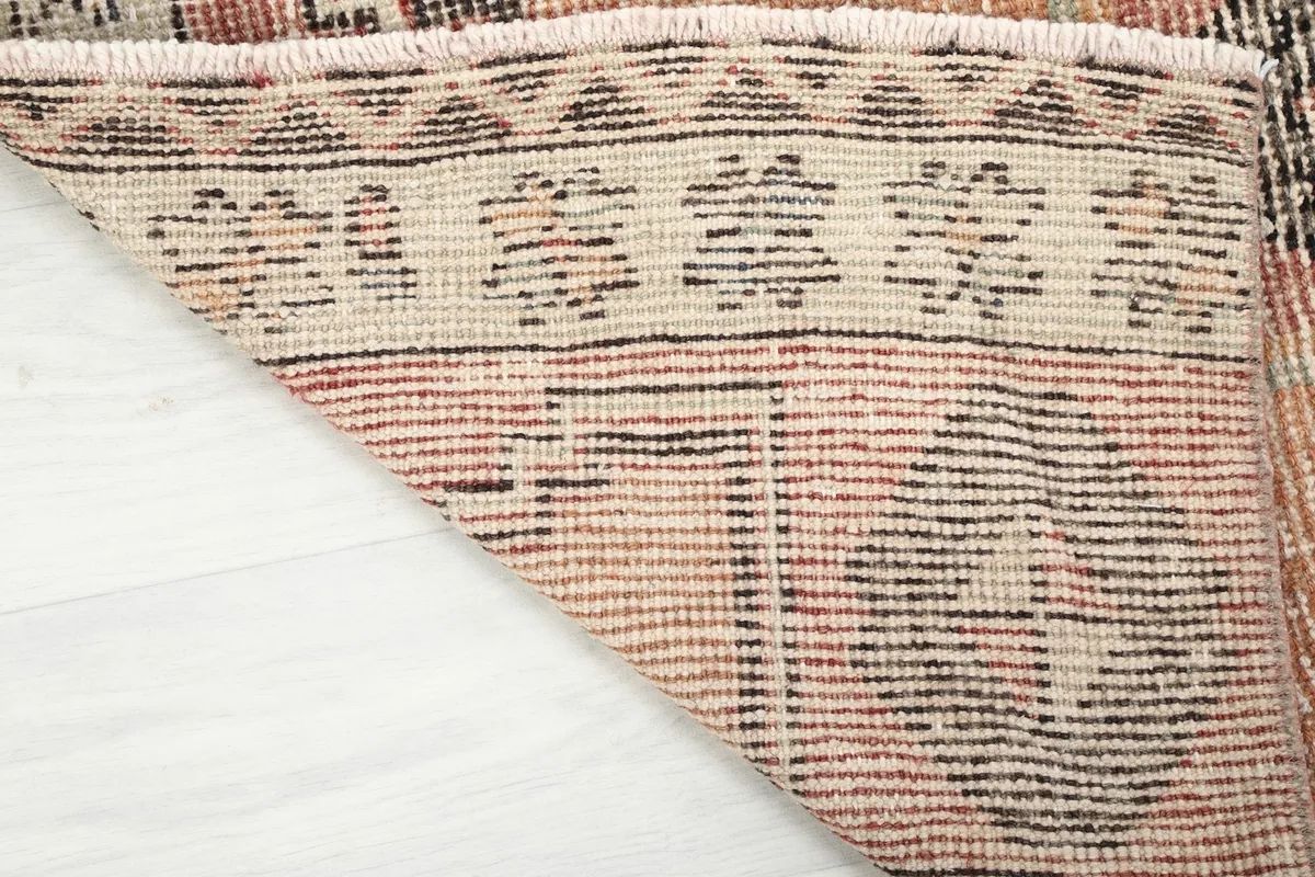 Underside of the hand-knotted rug, revealing the cotton foundation and construction