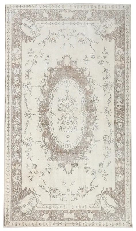 Full top view of the 5'5" x 9'7" ivory and beige vintage Anatolian rug on a white background