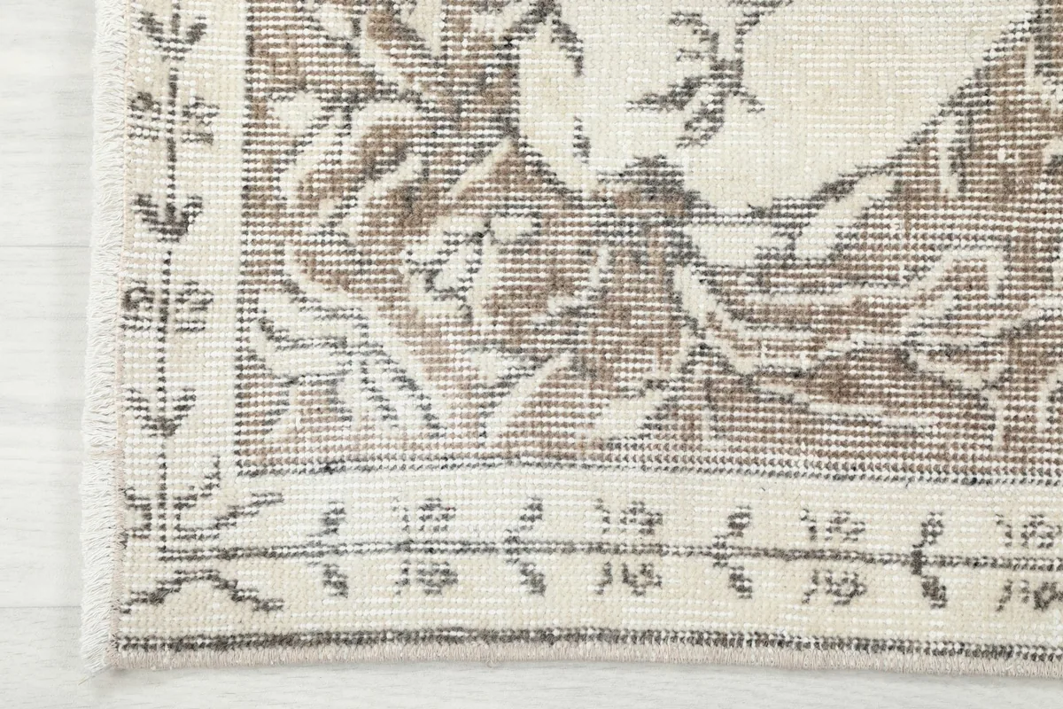 Close-up of the rug's outer border design, showing the intricate patterns and edge finishing