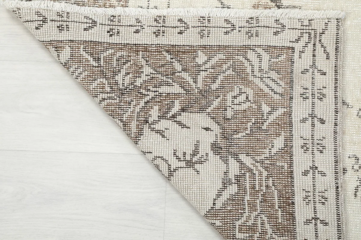 Detailed view of the rug's underside, showing the hand-knotted construction and cotton foundation