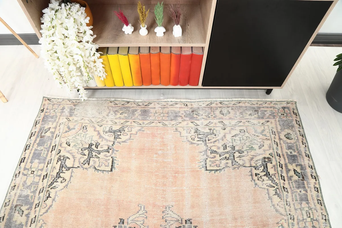 Top-down view of one end of the rug, showing the border and field design