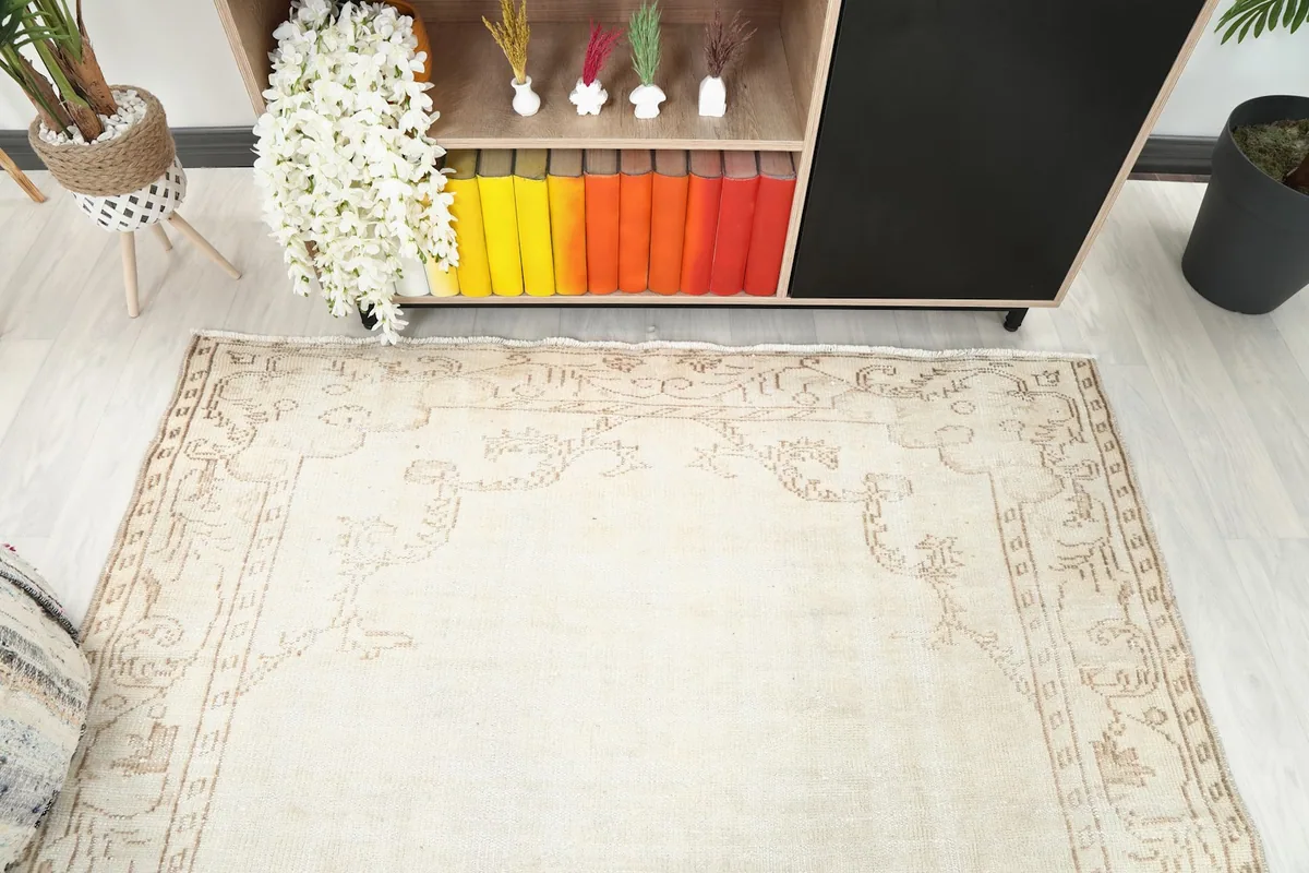 Detailed angle of the rug's top edge and border pattern, seen from above, near a console table.