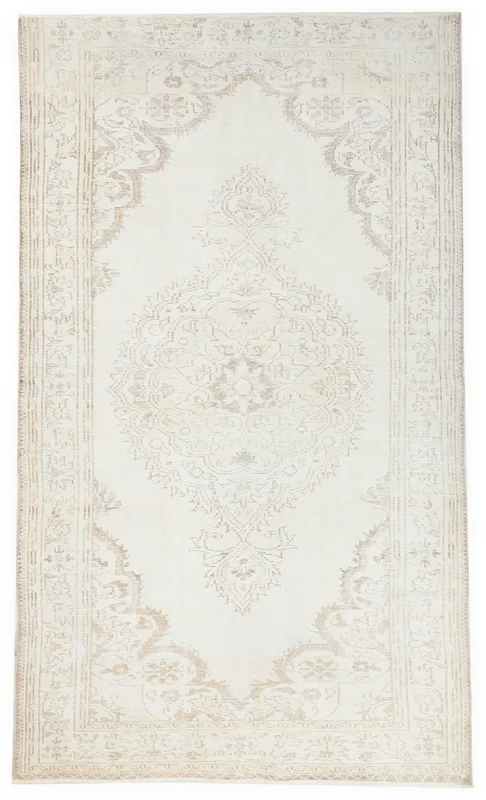 Full top view of the 5'6" x 9'3" vintage Anatolian rug with a cream field and beige medallion.