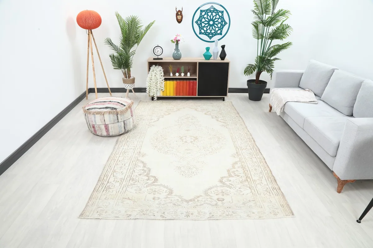 Overhead view of the cream and beige rug styled in a modern living room setting.