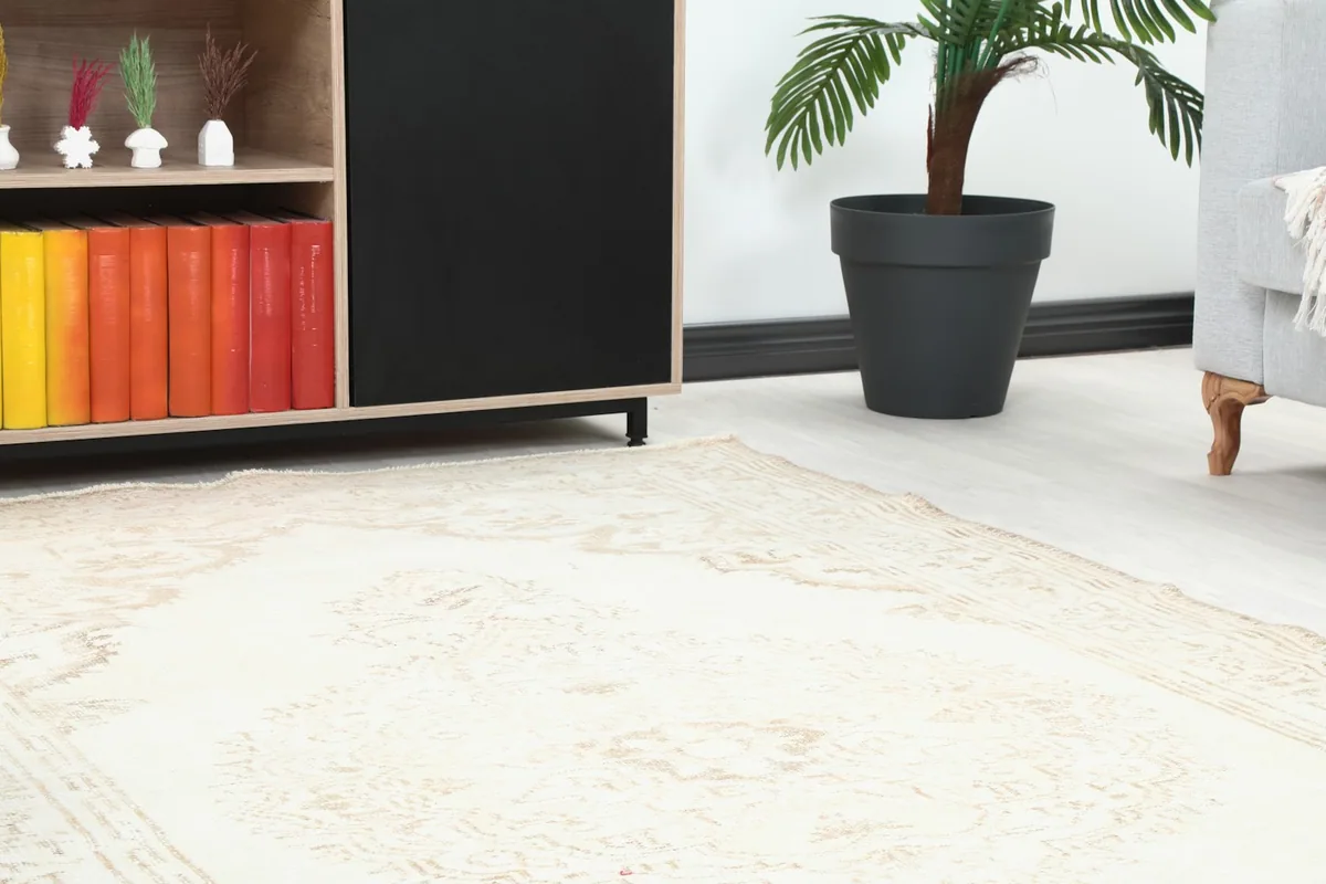 Close-up of the rug's border and corner, showing its integration with furniture in a room.