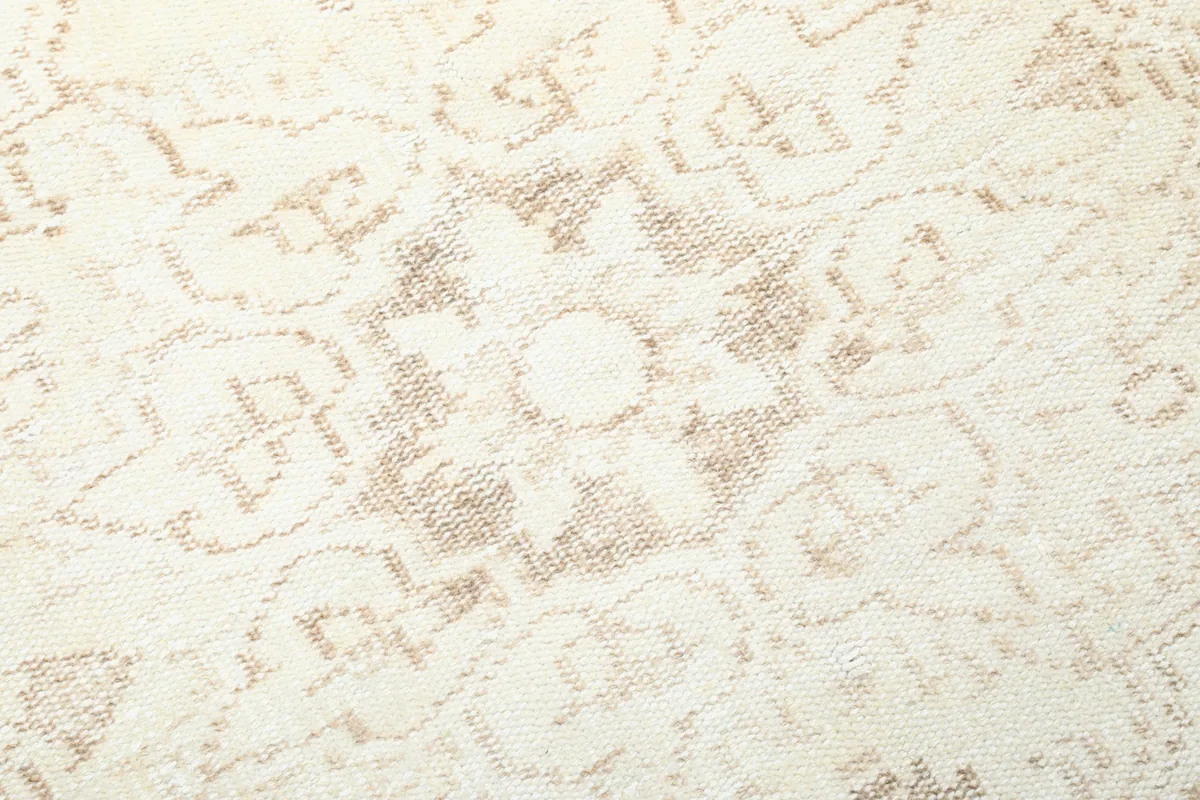 Close-up of the geometric patterns and distressed texture of the wool pile.