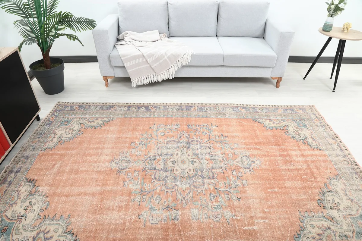 Overhead view of the rug in a room, capturing its full size in relation to a sofa