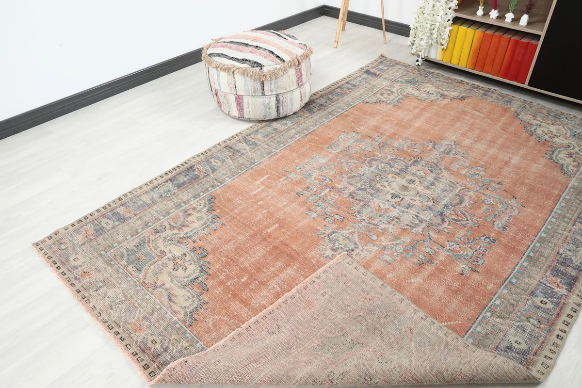 Corner of the rug lifted to show the back of the hand-knotted cotton foundation