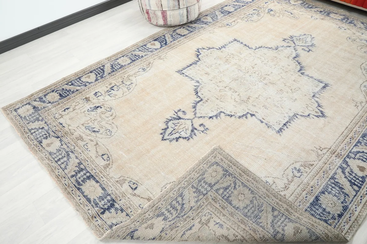 A corner of the rug folded back, showing the thickness and construction