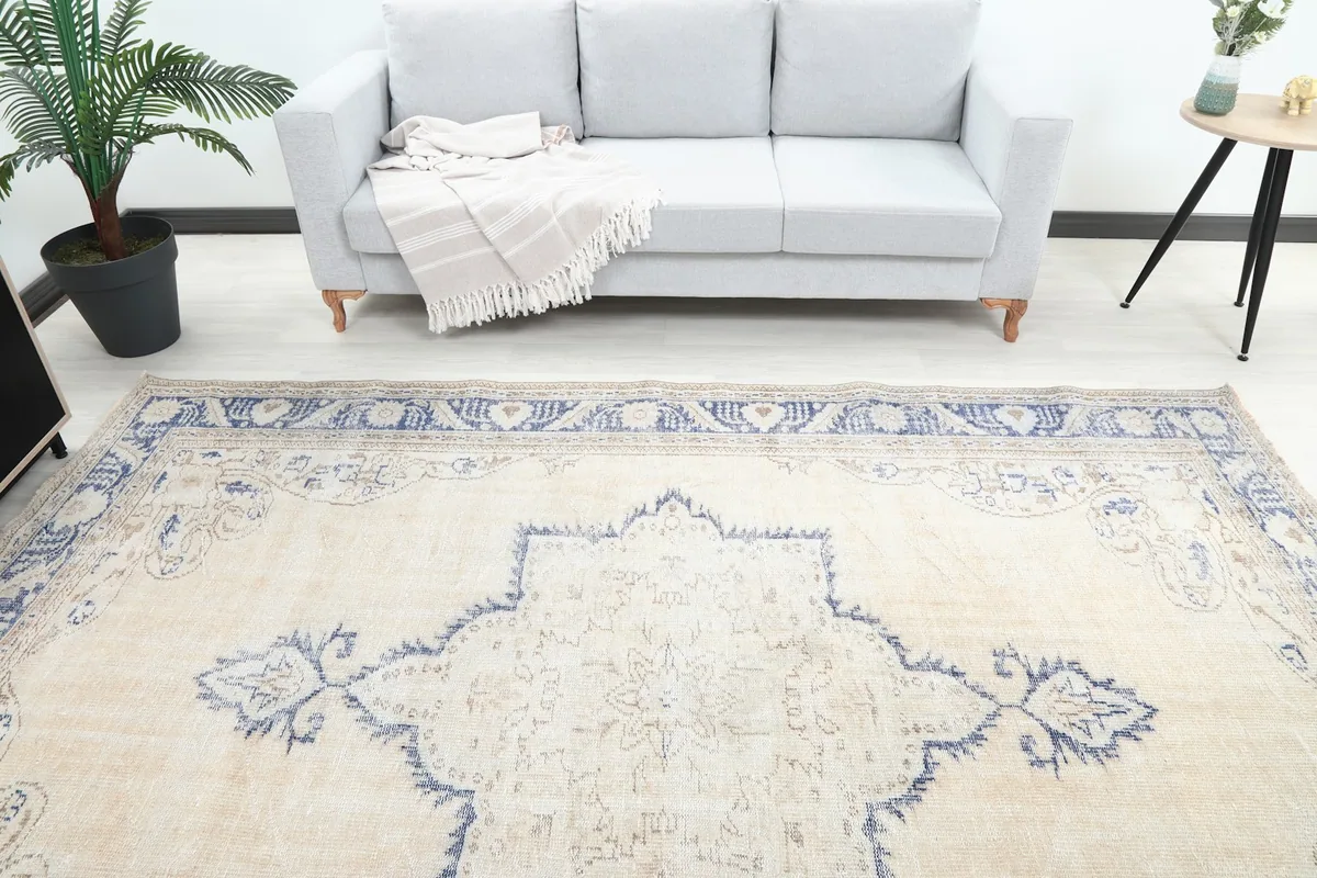 Overhead view showing the rug's central medallion and colors in a room