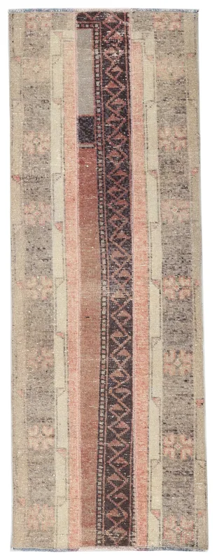 Full overhead view of the beige and rust vintage Anatolian runner rug on a white background.