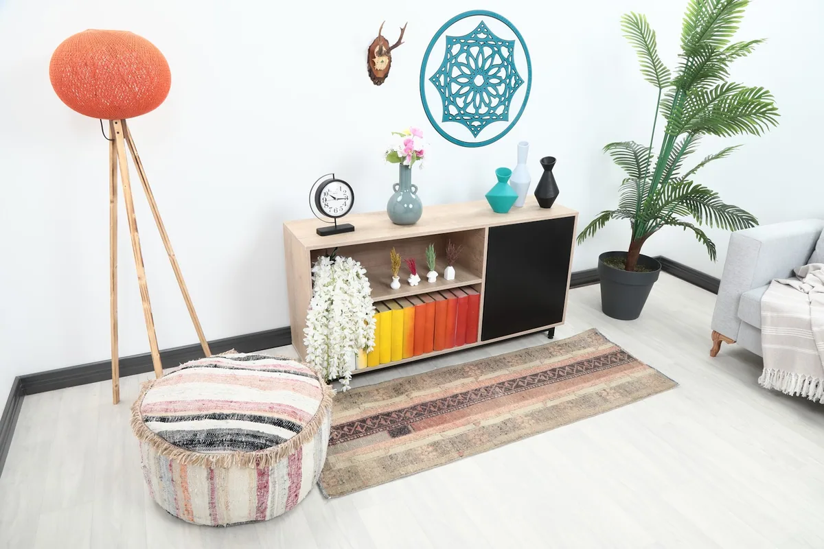 Overhead angle of the vintage runner rug placed in a room setting, showing its length and colors.