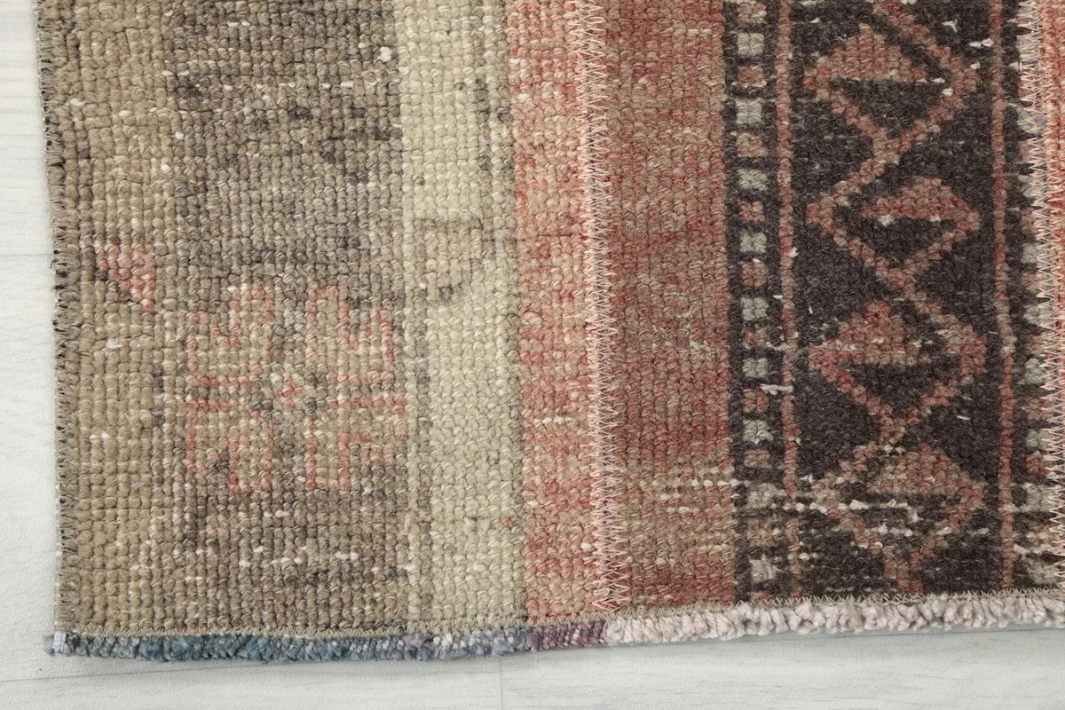 Close-up showing the low pile and texture of the vintage wool runner, with slight wear visible.
