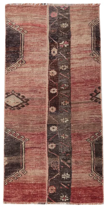 Full overhead view of the vintage 2x4 rose and brown tribal Anatolian rug on a white background