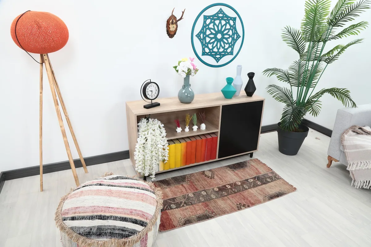 Overhead view of the mini tribal rug in a room setting, showing its scale with furniture