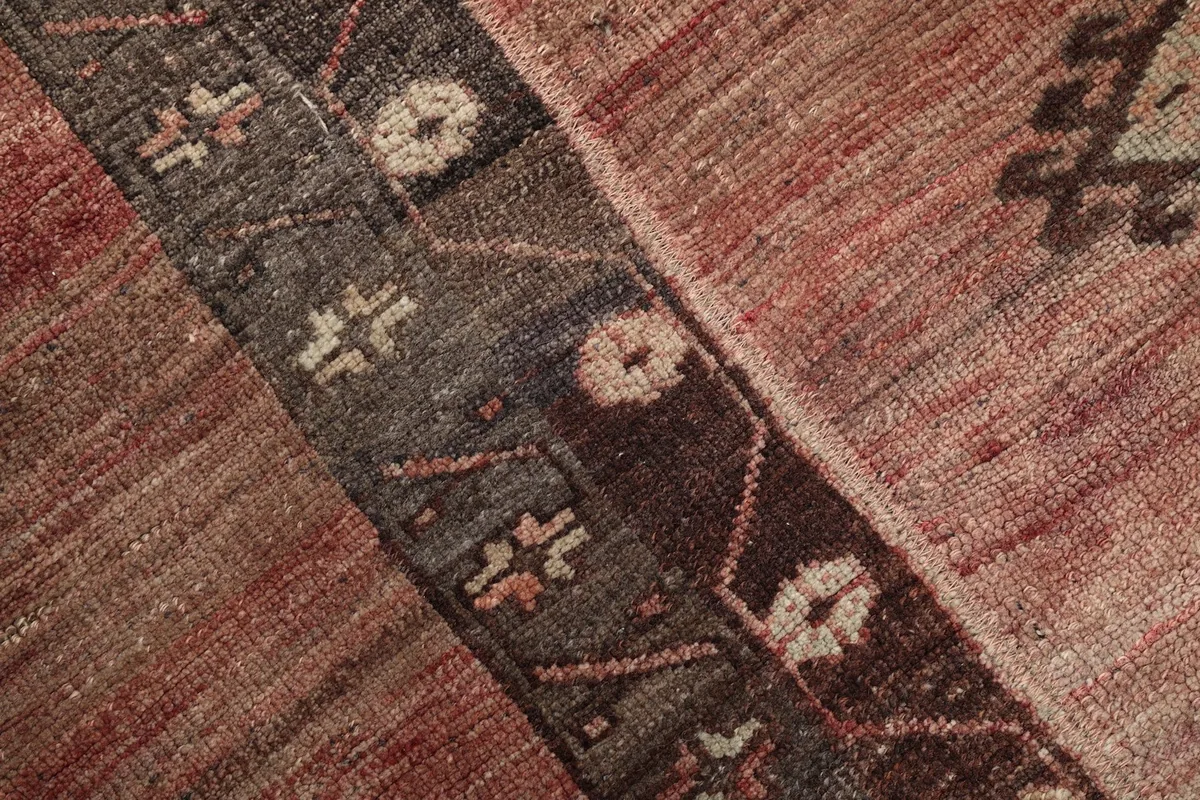 Close-up detail of the rug's central design and color blending in the wool pile