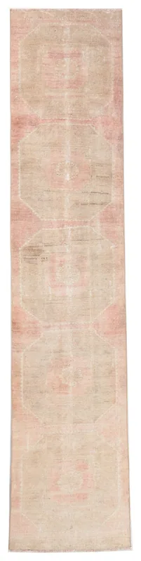 Full top view of the beige and rose vintage Anatolian geometric runner rug on a white background