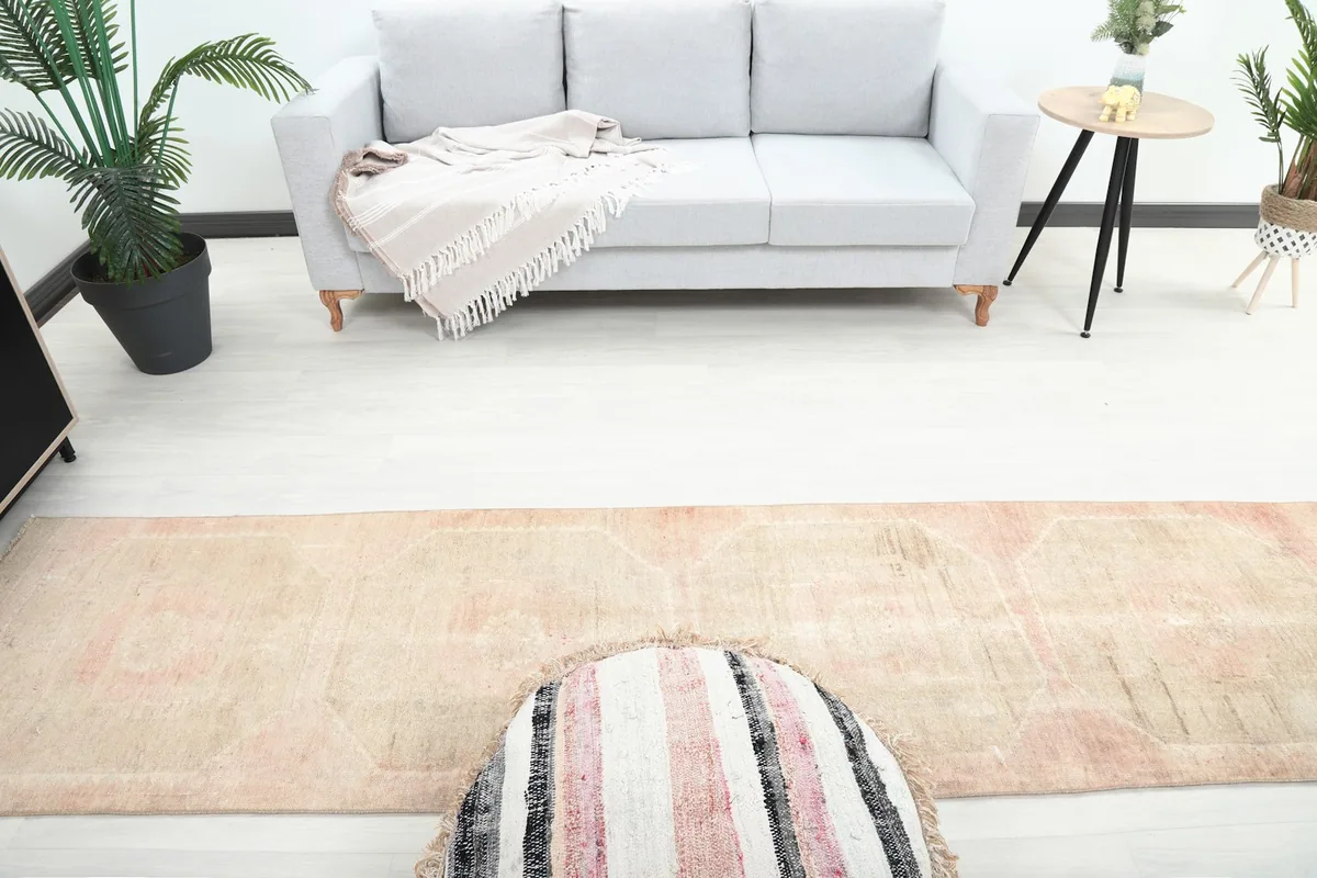 Overhead view of the beige and rose runner rug in a room, showing its placement relative to furniture