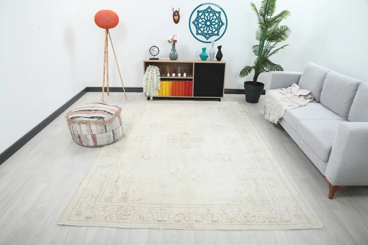 Ivory gold vintage rug styled in a living room setting, showcasing its medium size