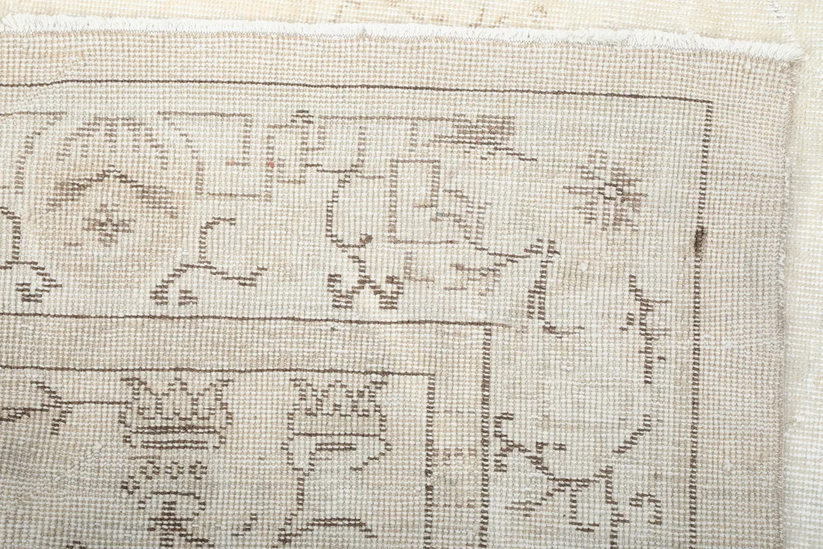 Close-up of the rug's reverse side, showing the cotton foundation and hand-knotting detail