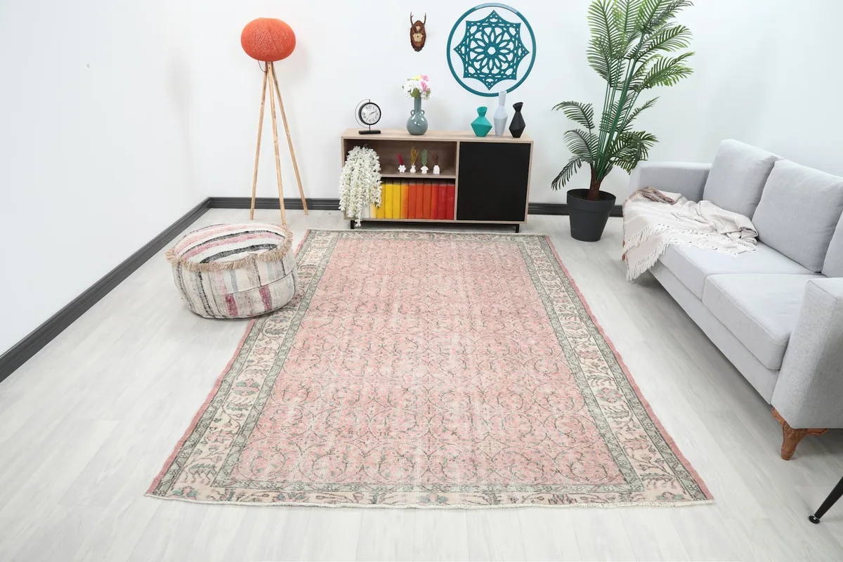 Rose Anatolian rug displayed in a modern living room setting with a light gray sofa