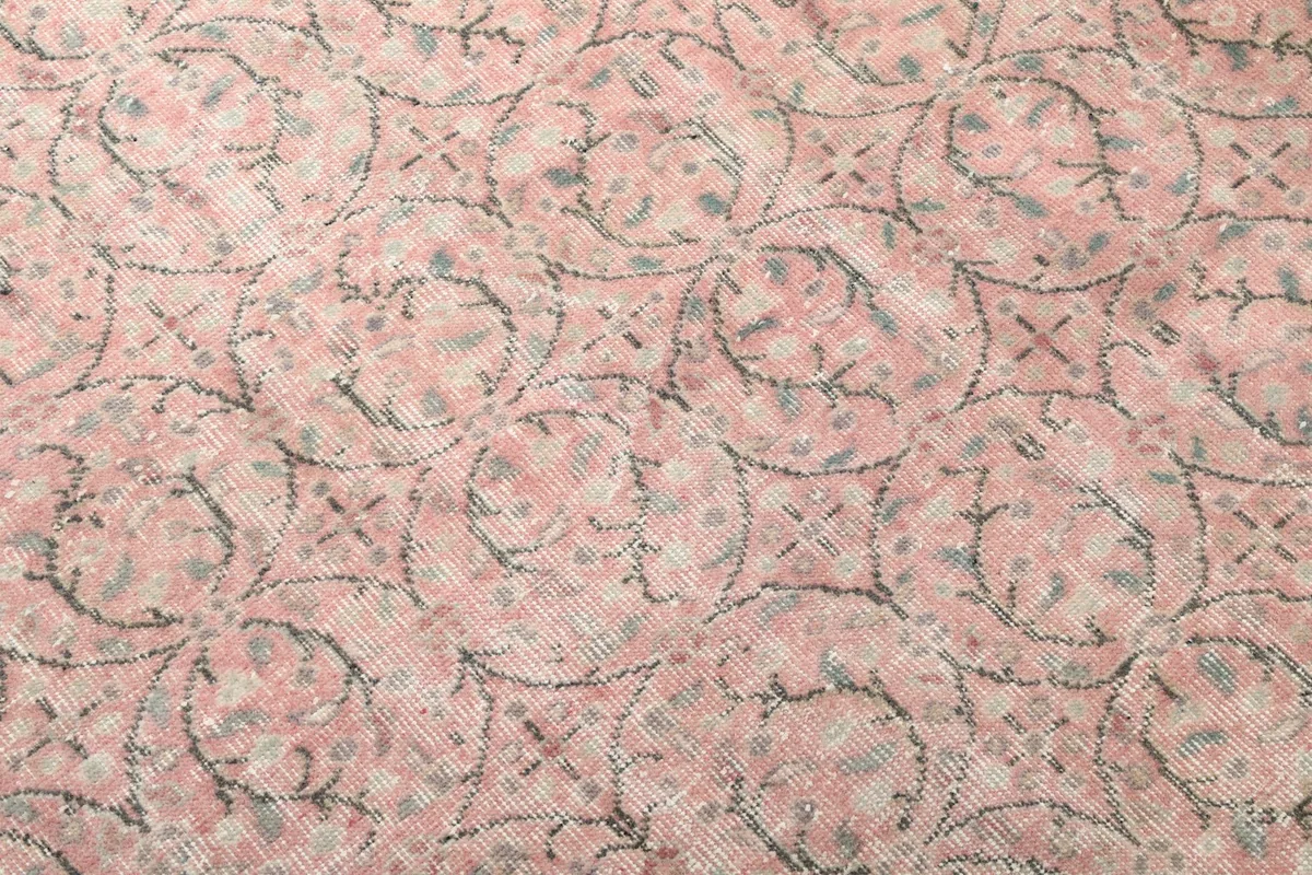 Close-up of the rose rug's hand-knotted pile and intricate floral-geometric motif