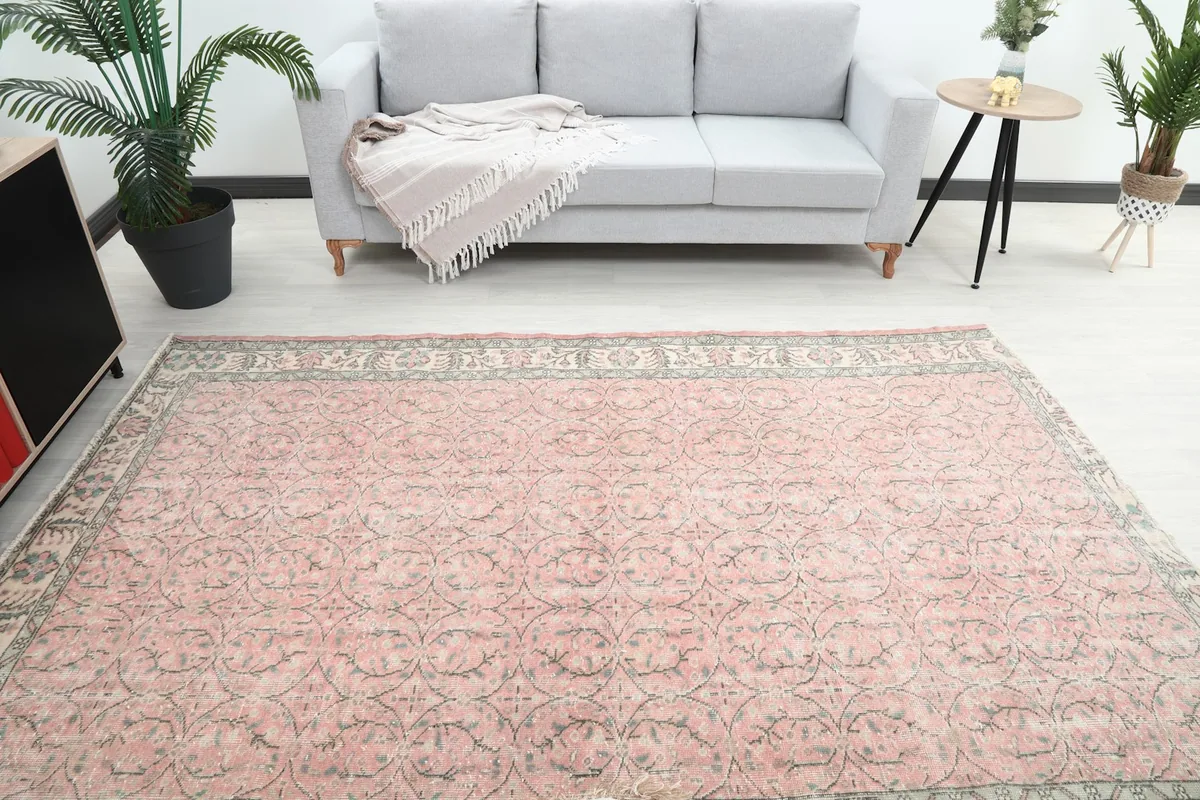 Overhead view of the rug placed in a room, showing its scale relative to a sofa