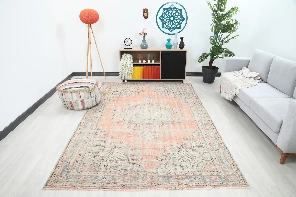 Vintage Anatolian rug in a living room setting with a gray sofa and light wood furniture