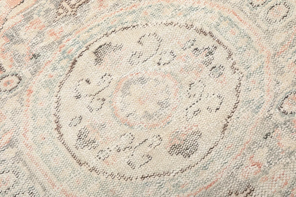 Close-up of the hand-knotted wool pile, showing texture and color variations